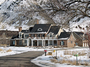 A mansion sitting against a mountain backdrop